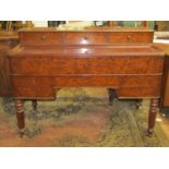 A mid 19th century continental plum pudding mahogany enclosed writing desk, the front elevation