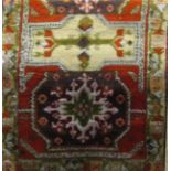 A coarse wool rug in the Persian style with geometric detail, upon a cream ground, 160 x 95cm