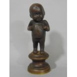 Cast bronze study of a standing cupid upon a stepped circular bronze base, 12 cm high