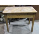 A small vintage pine kitchen table of rectangular form with rounded corners and single end frieze