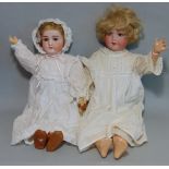 2 German bisque head dolls both with blue sleeping eyes, open mouth with teeth, short fair hair,