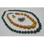 String of graduated amber coloured beads (one bead af), together with a further malachite bead