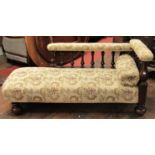 An unusual Victorian chaise longue with turned mahogany supports and raised on four bun feet with