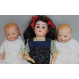 3 small German dolls including a shoulder head doll with fixed brown eyes, wooden arms and cloth