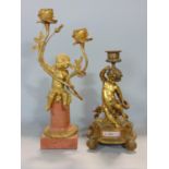 Ormolu novelty twin branch candlestick in the form of a seated cherub upon a Corinthian plinth, 32