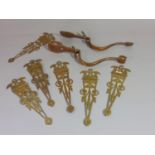 A pair of Arts & Crafts brass door handles with thumb latches, together with a set of six late