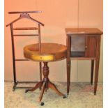 An Edwardian mahogany night table in the Georgian style enclosed by a sliding tambour door raised on