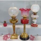 A collection of various oil lamps and parts comprising a Harrison & Co of London brass Corinthian