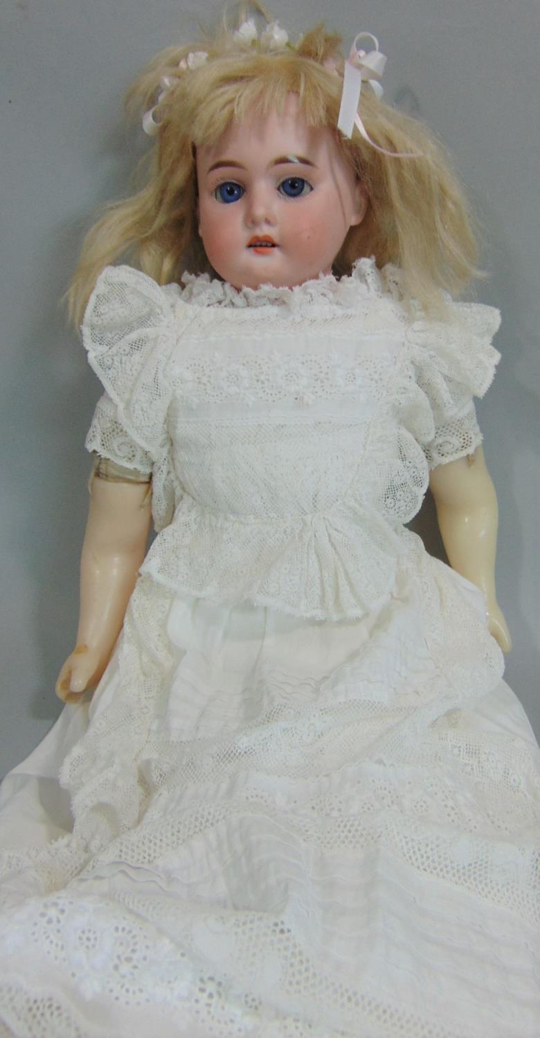 Early bisque shoulder- headed doll by Armand Marseille with soft body and wax lower limbs, blue