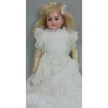 Early bisque shoulder- headed doll by Armand Marseille with soft body and wax lower limbs, blue