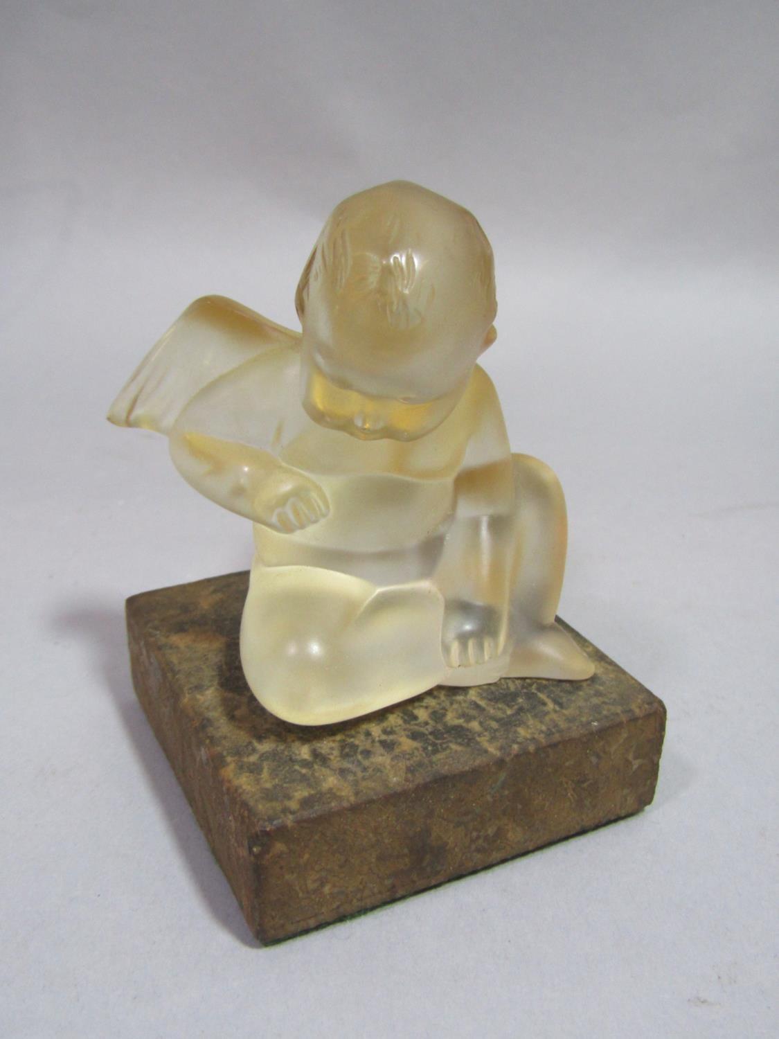 Early 20th century Lalique study of a seated putti/cherub, 8 cm high