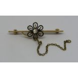 Antique yellow metal bar brooch with diamond set flower head motif, 4.4cm wide approx, 4.5g