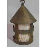 An Arts & Crafts style hall lantern of cylindrical form with mottled coloured glass shade beneath