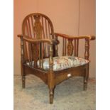 A Windsor stained elm and beechwood hoop and stick back elbow chair with pierced splat, together