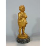 Jose Dunach (1886-1957) - cast gilt bronze study of a standing girl wearing a frilly dress holding a