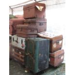 Two vintage timber lathe bound cabin trunks of varying design and eight domed top tin trunks of