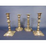 Two pairs of Sheffield plated candlesticks, one with cannon type columns, the other more Rococo in