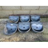 Six small galvanised iron water feeders