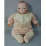 A bisque headed baby doll "Bye-Lo Baby", by Grace Storey Putnam, circa 1925, height 44cm with soft