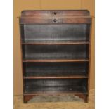 A 1920s slender oak freestanding open bookcase with three fixed shelves, blind fret and moulded