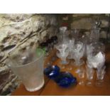 A collection of glassware including two cut glass decanters and stoppers, further decanter and