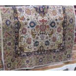 A wool carpet in the Persian style with white ground and abstract floral detail, within further
