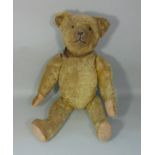 A good old teddy bear, circa 1930's with boot button eyes, stitched nose and mouth, clipped
