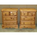 A pair of small solid pine Victorian style bedroom chests of two short over two long drawers