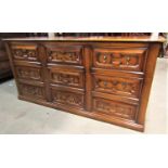 A good quality reproduction oak dresser base in the Jacobean style with distressed finish, fitted