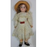 Jumeau bisque head doll marked in red 'Depose Tete Jumeau 12' with fixed blue eyes, closed mouth,