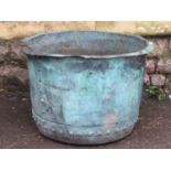 An old weathered verdigris copper with riveted seams and flared rim (with repair and drilled