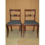 A set of seven Regency rosewood bar back dining chairs with carved splats over drop in upholstered