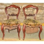 A set of six Victorian mahogany balloonback dining chairs with scrolled splats, carpet upholstered