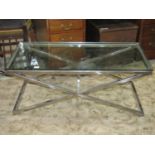 A good quality modernist occasional table with thick rectangular plate glass top raised on chrome