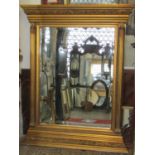 A large contemporary wall mirror with rectangular bevelled edge plate within a composite stepped and