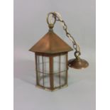 An Arts & Crafts copper hall/porch lantern of hexagonal form with glazed and barred panels 32 cm