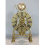 A brass single fuse skeleton clock with brass chapter ring enamelled with Roman numerals, striking