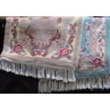 Two small Indian rugs in pastel shades with floral detail, 140 x 70cm approx (2)
