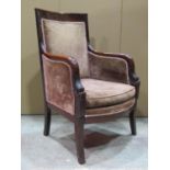 A Regency chair with upholstered seat and back with down swept carved stylised dolphin arms and