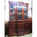 A good quality Victorian style mahogany three door breakfront library bookcase, the lower section