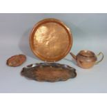 An Arts & Crafts Cornish copper tray of oval form with raised crimped edge, fish and hammered