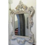 A contemporary reproduction wall mirror, the composite frame with scrolling acanthus and simulated