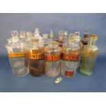 Large collection of clear glass apothecary bottles many with original gilt labels inscribed Sp.
