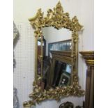A large Chippendale style wall mirror with carved C scroll acanthus and broken arch frame, 137 cm