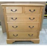 A Georgian style stripped pine bedroom chest of two short over three long graduated drawers, flanked
