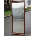 An Edwardian/1920s full length dressing mirror with rectangular bevelled edge plate within a moulded