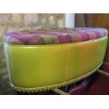 A large oval stool with buttoned tartan style upholstered seat and lime green coloured leatherette