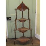 A Victorian walnut and figured walnut four tier tapering corner whatnot with spiral twist