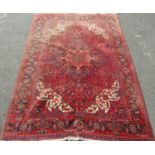 A good quality full pile Hamadan village carpet with scrolled floral and medallion decoration with
