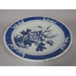 An oriental blue and white charger with peony, bird and insect detail, 37.5 cm diameter